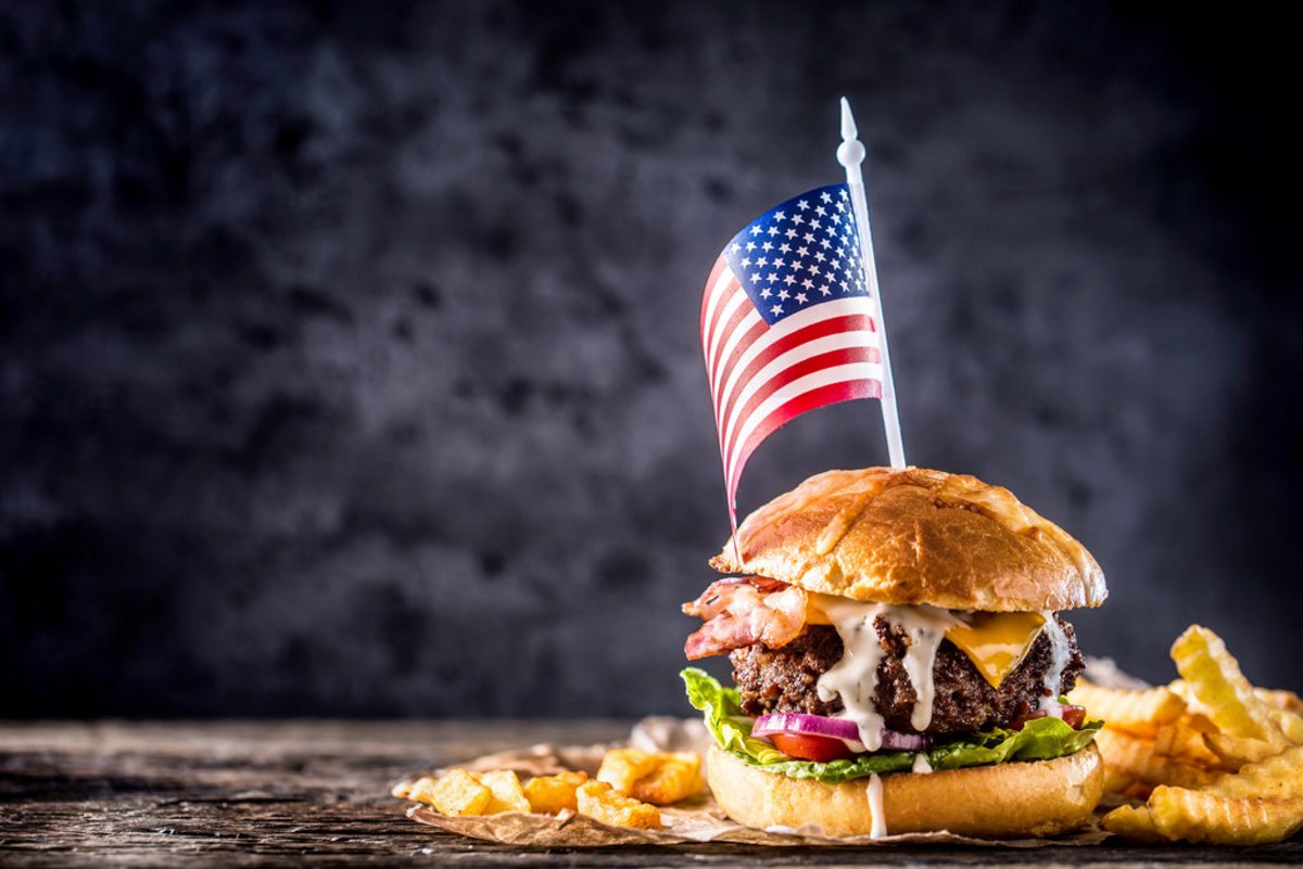 Close-up home made beef burger with american flag and fries on w AdobeStock_210271842.jpeg